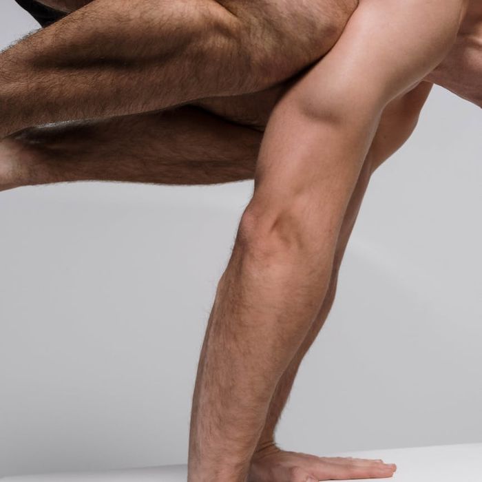 Aesthetic shot of a man balancing on one leg, symbolizing stability and focus.